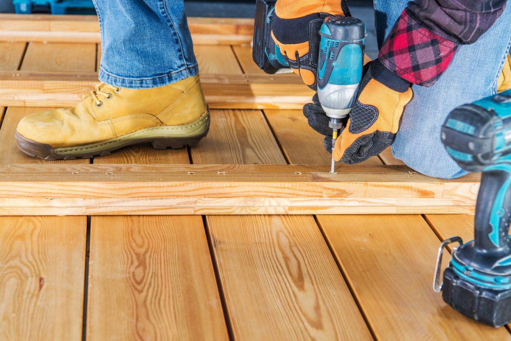 professional man finishing up a new deck